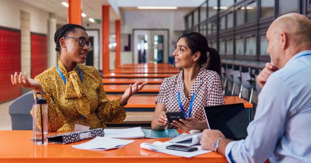 Teacher Collaboration Meeting Teachers collaborating in a school meeting to share creative classroom strategies.